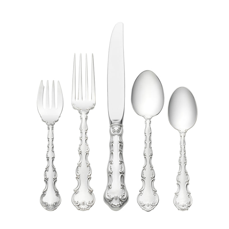 Sterling silver flatware set with ornate handles: fork, knife, and spoons