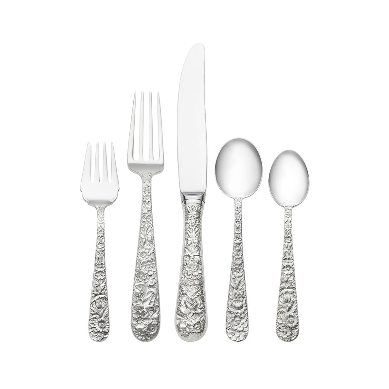 Ornate repousse-style flatware set with etched handles: forks, knife, and spoons