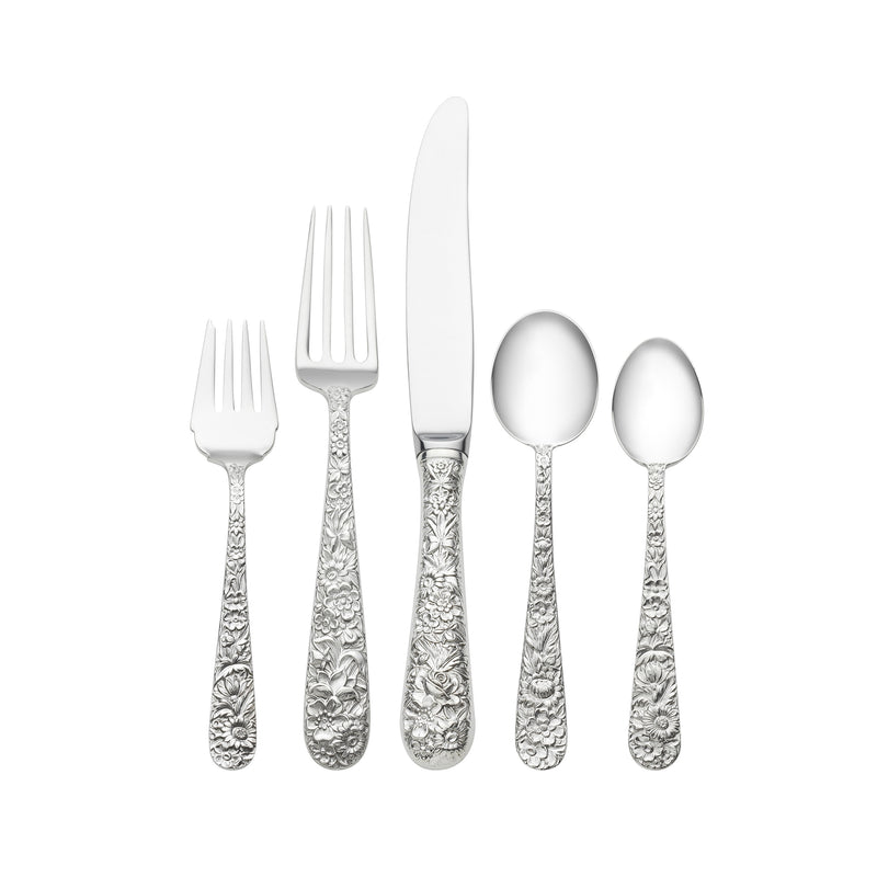 Silver flatware set with repousse patterned handles, includes forks, knife and spoons