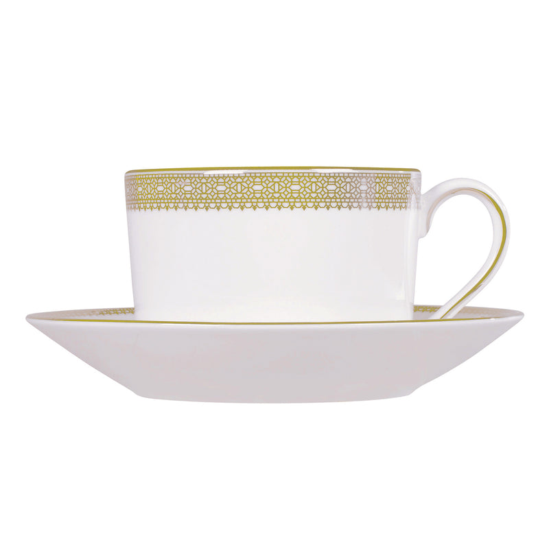Porcelain teacup and saucer with gold lattice lace trim and matching handle