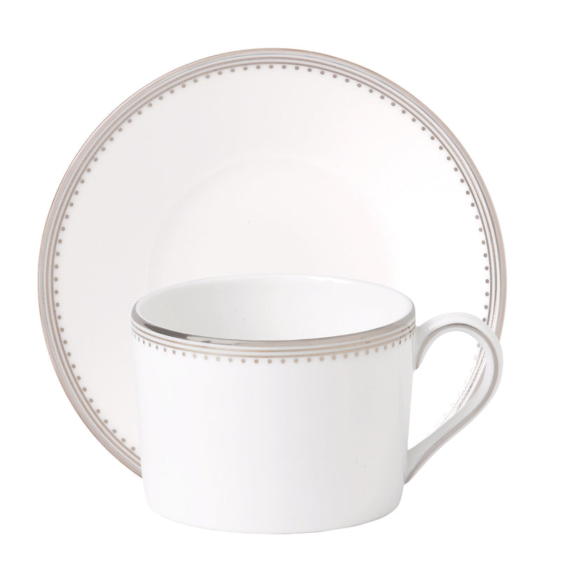 White porcelain teacup with gold grosgrain-style dotted rim and band, matching handle