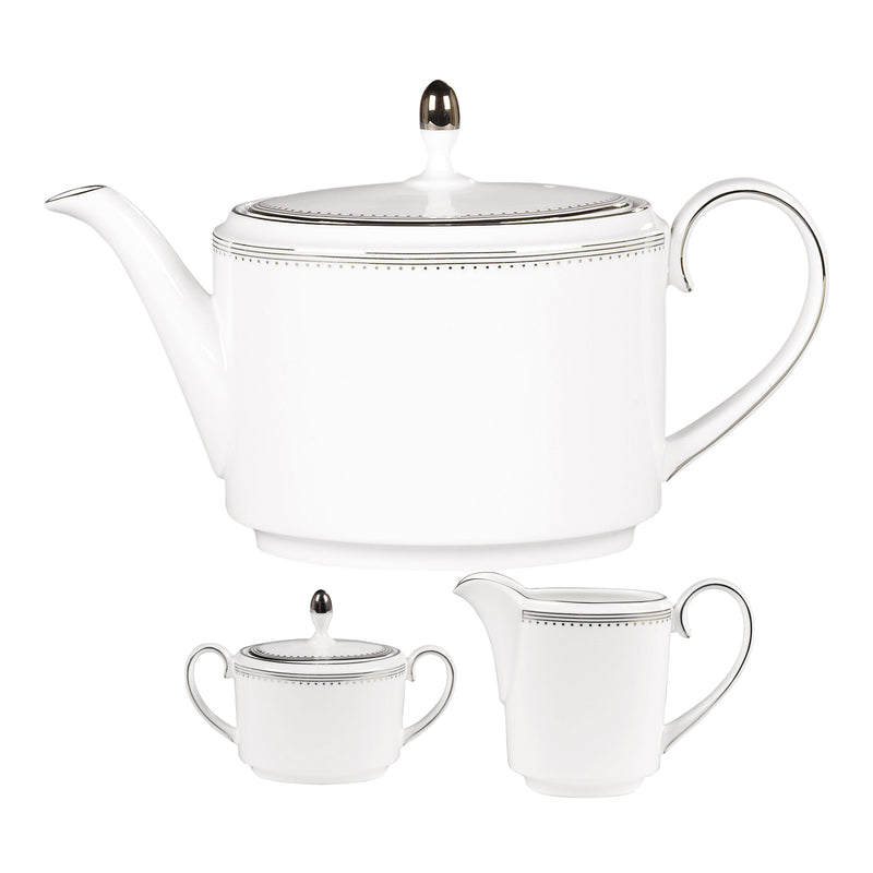 White porcelain tea service with grosgrain border and gold trim, teapot and bowls