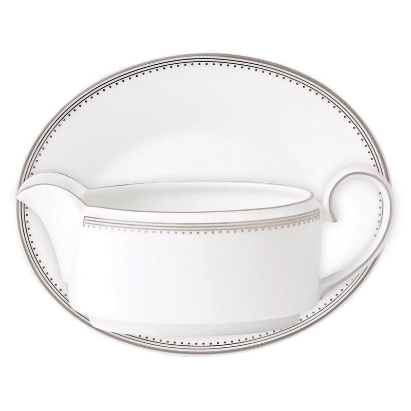 White ceramic gravy boat with black dotted rim and grosgrain-style stripe detail