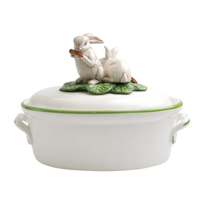 White ceramic tureen with bunny lid and green vegetable garnish