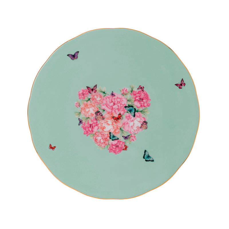 Round green cake plate with pink floral centerpiece and butterfly accents