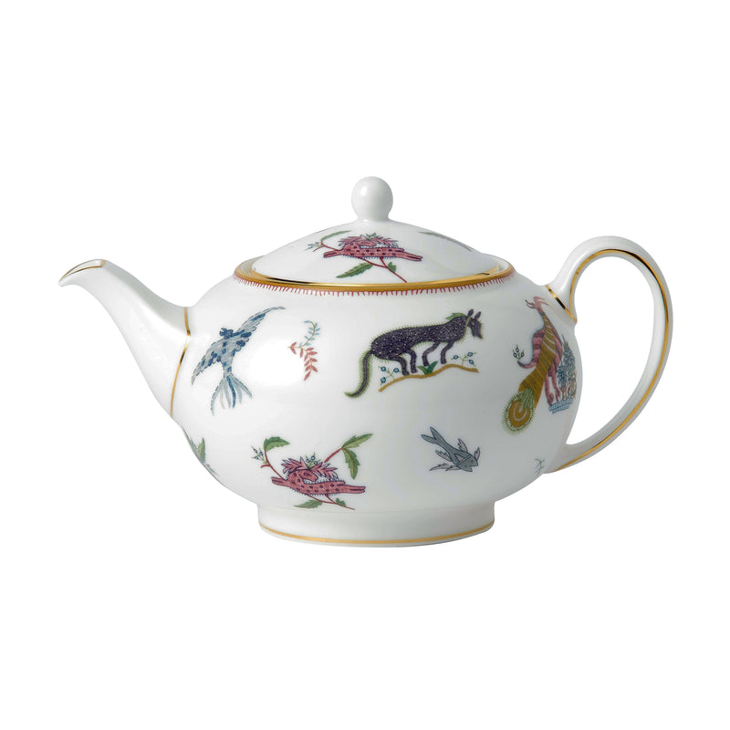 White ceramic teapot with mythical creature pattern, gold-trimmed lid and spout