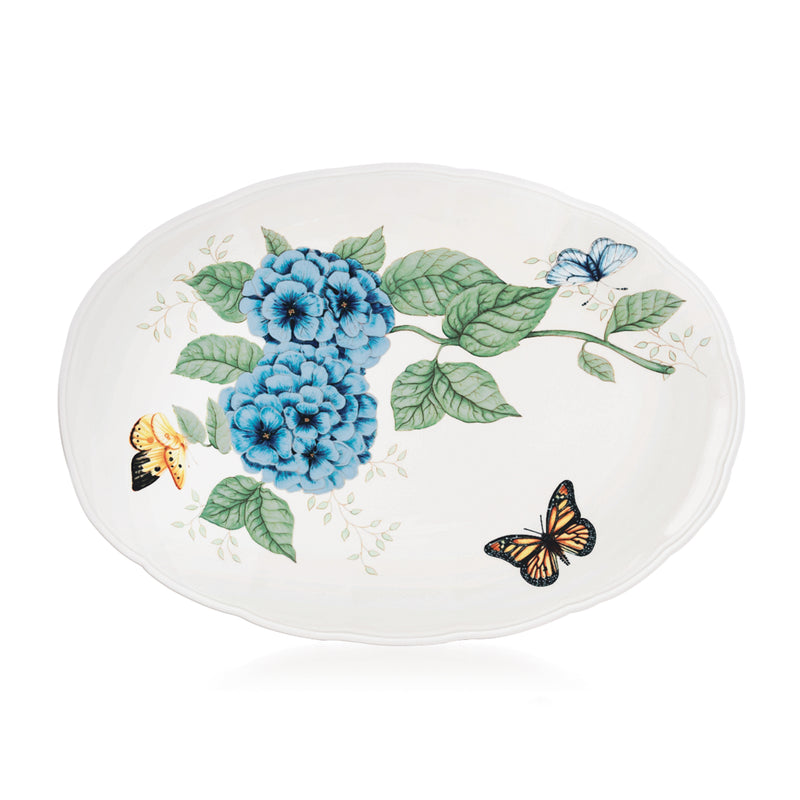 Oval porcelain platter with blue hydrangea florals, green leaves, and butterflies on white