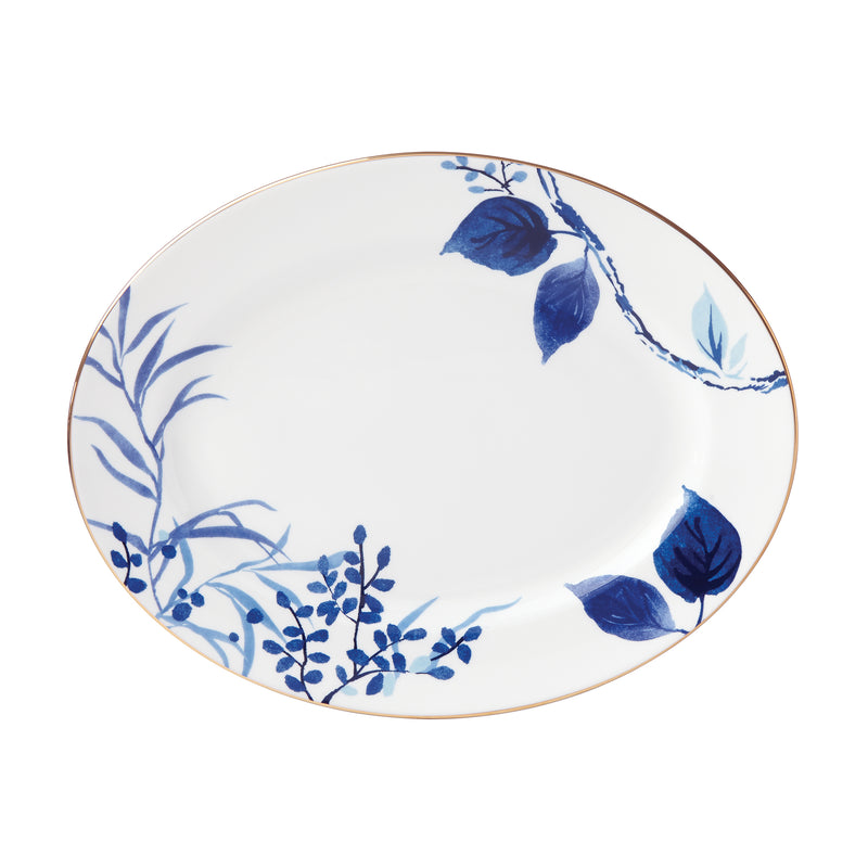 Oval ceramic platter with dark blue botanical leaf pattern and thin gold rim