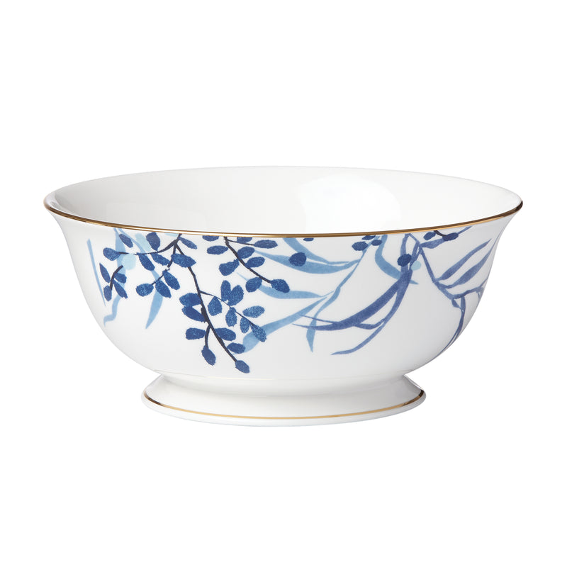 Indigo serving bowl with blue floral pattern and gold trim, white ceramic
