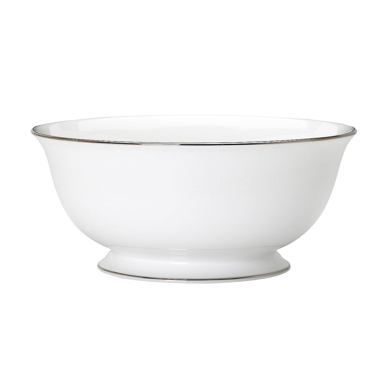 Serving bowl in white ceramic with thin metallic rim around edge