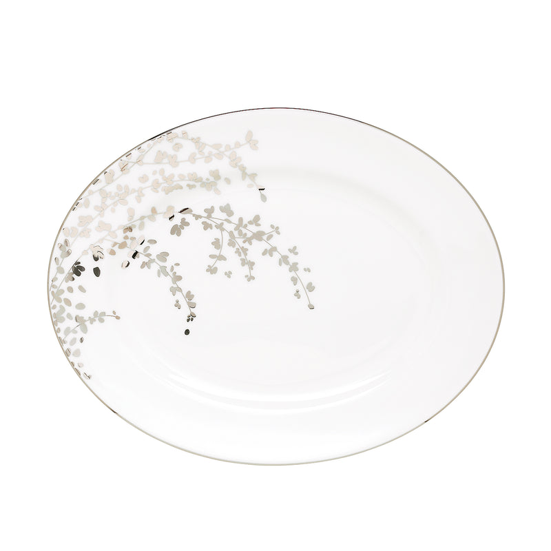 White oval platter with gold rim and delicate floral sprig pattern