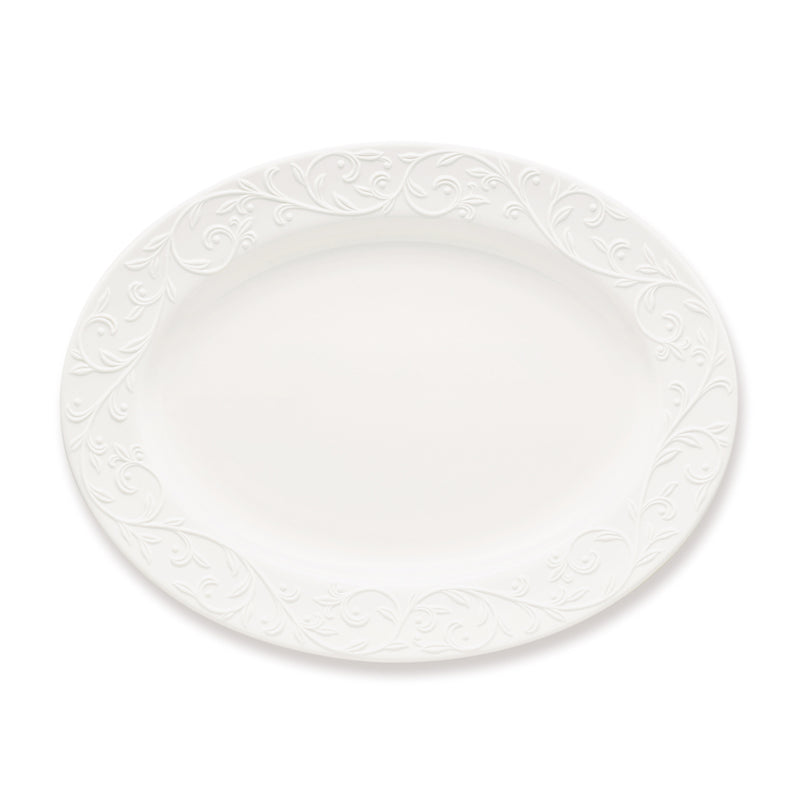 White oval porcelain platter with embossed scrollwork rim
