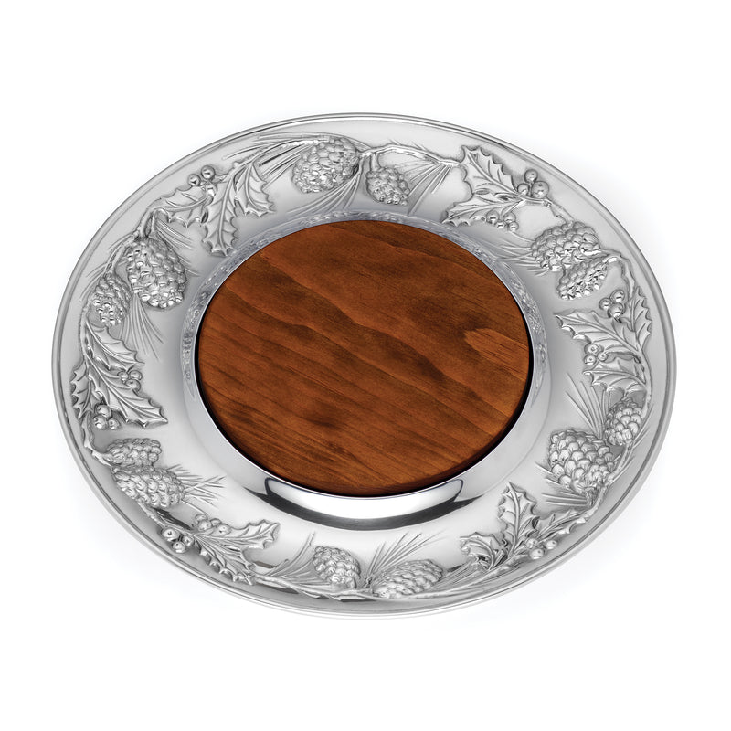 Round metal cheese board with embossed fruit border and dark wooden center