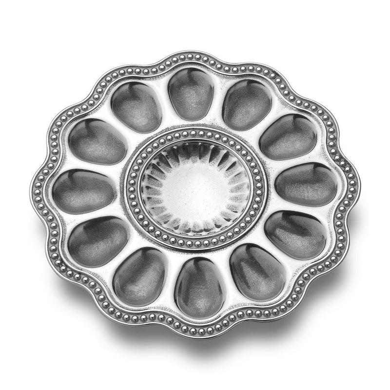 Round metal deviled egg serving tray with fluted rim and 10 egg cups, plus center dish