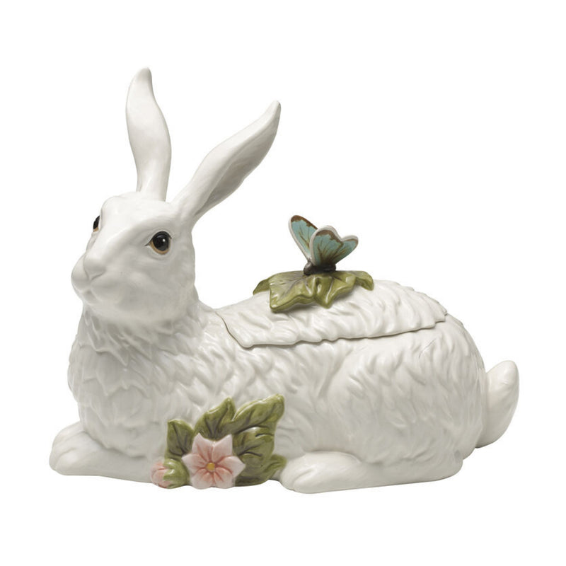 White ceramic rabbit cookie jar with leaf-and-flower lid topper
