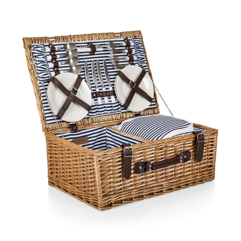 Wicker picnic basket set for four with blue striped lining, leather straps, and utensils