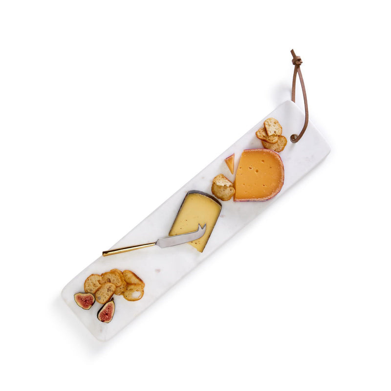 Elongated white marble serving tray with cheese knife and cheese assortments