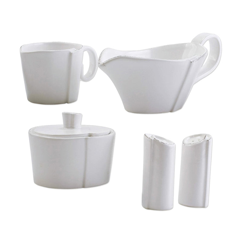 White ceramic accessory set with two handled cups, covered dish, and two shakers