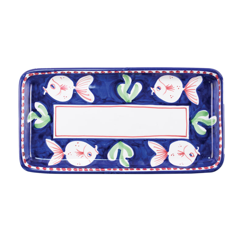 Blue ceramic rectangular platter with fish pattern and red-bordered center label