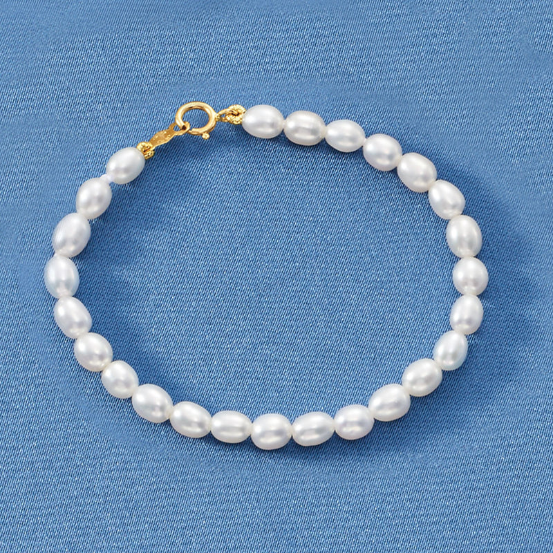 Children's cultured pearl bracelet with round white pearls and yellow-gold clasp link