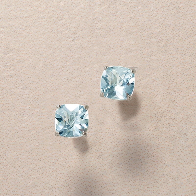 Cushion-cut aquamarine stud earrings in 14kt white gold, two light blue stones shown.