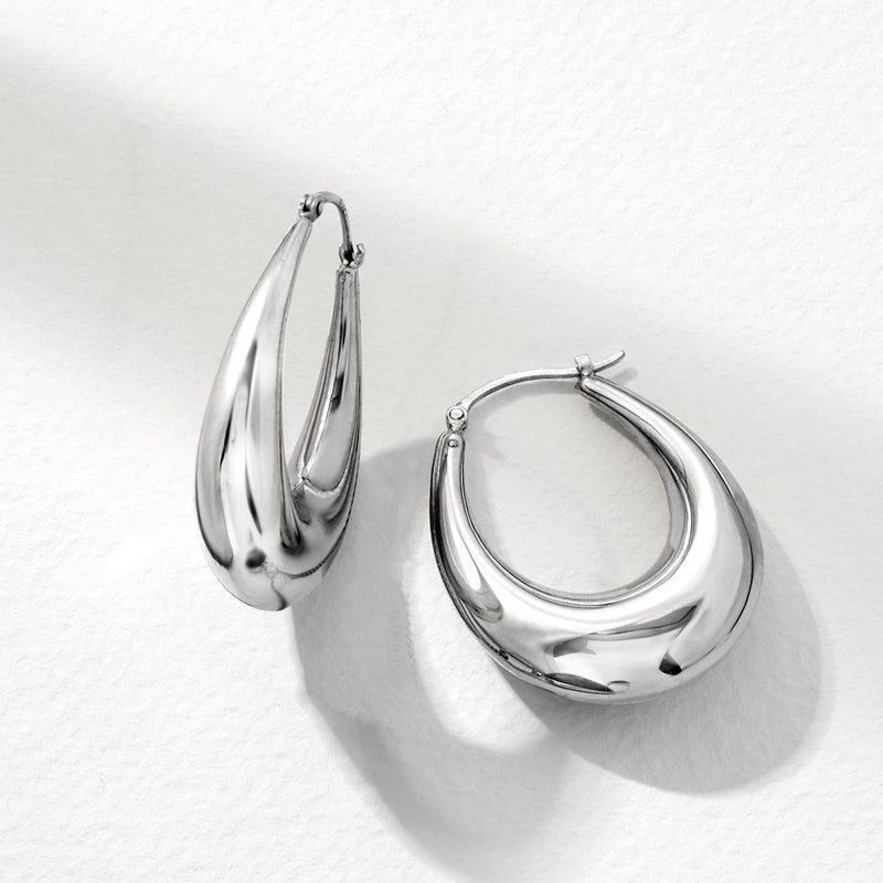 Layered sterling silver graduated hoop earrings with polished arcs, hook closure