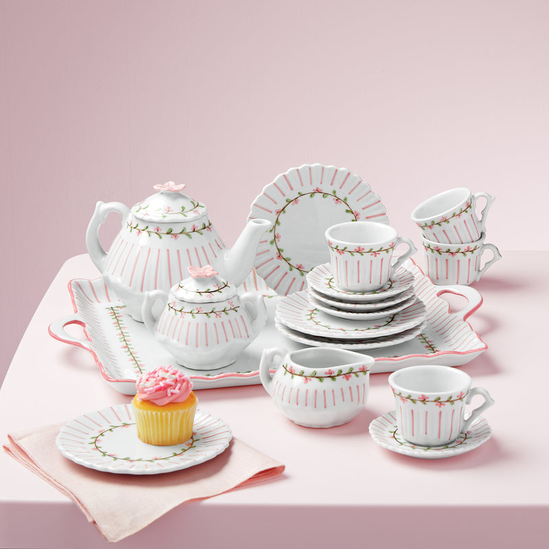 Children's porcelain tea set with pink rose accents and pinstripe cups, saucers, teapot