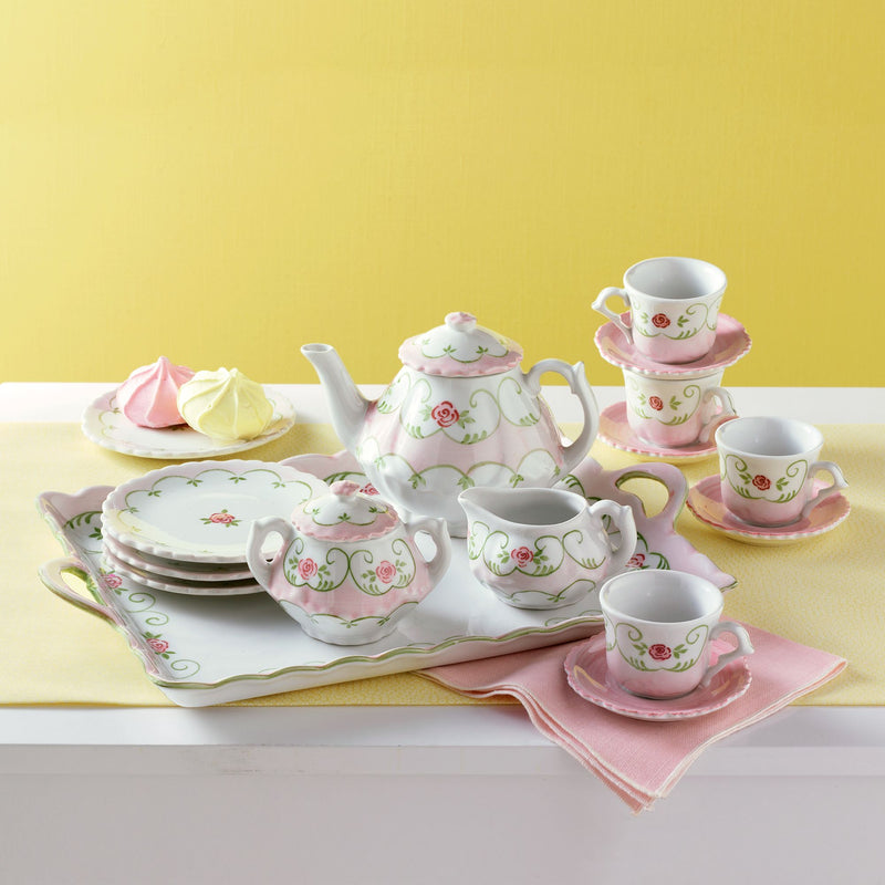 Kids porcelain tea set with pastel floral teapot, cups, saucers, and plates