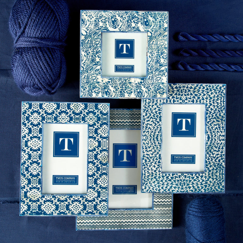 Set of four indigo-and-white batik pattern picture frames with blue T logos.