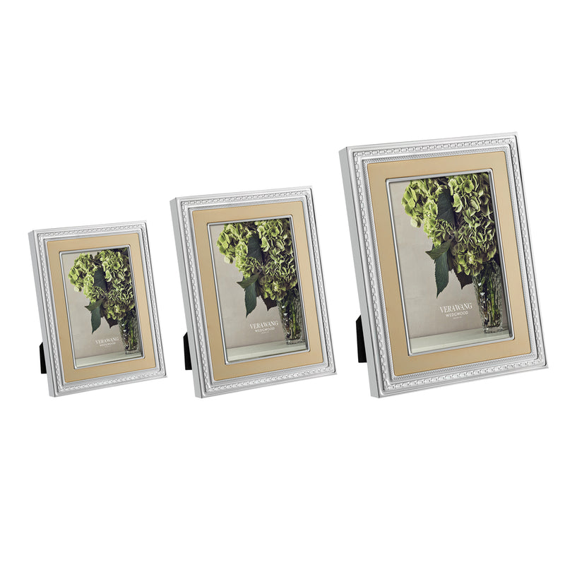 Silver-tone decorative picture frame with ornate border, gold mat, green floral photo