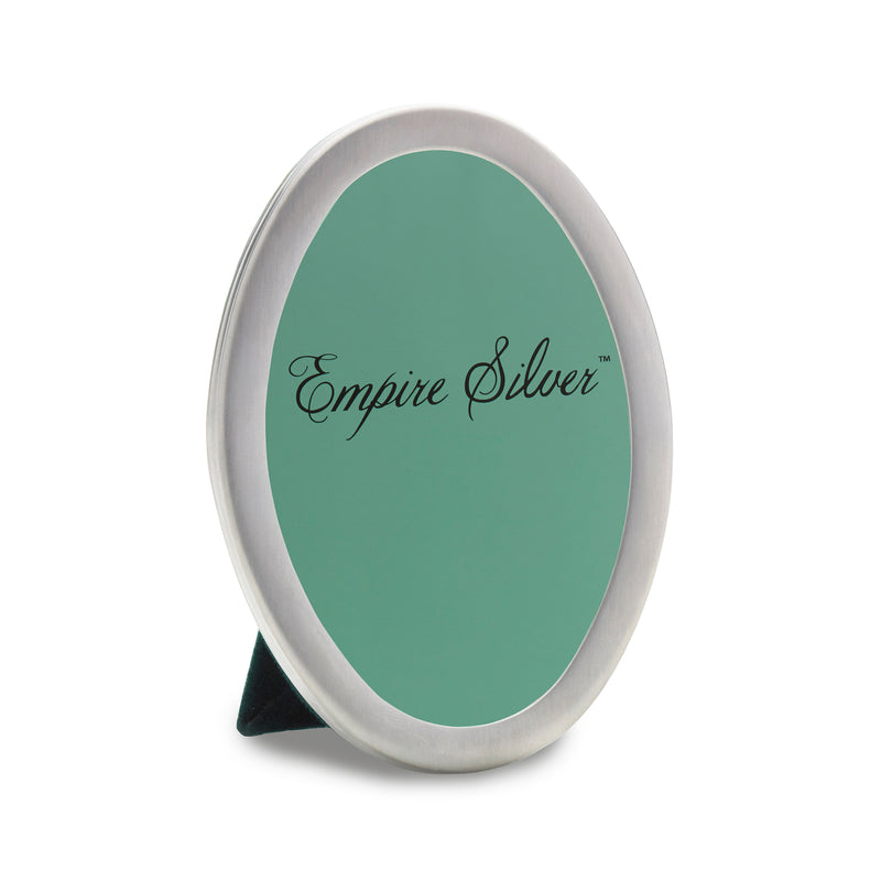 Small oval sterling silver photo frame with engraved logo on teal backing