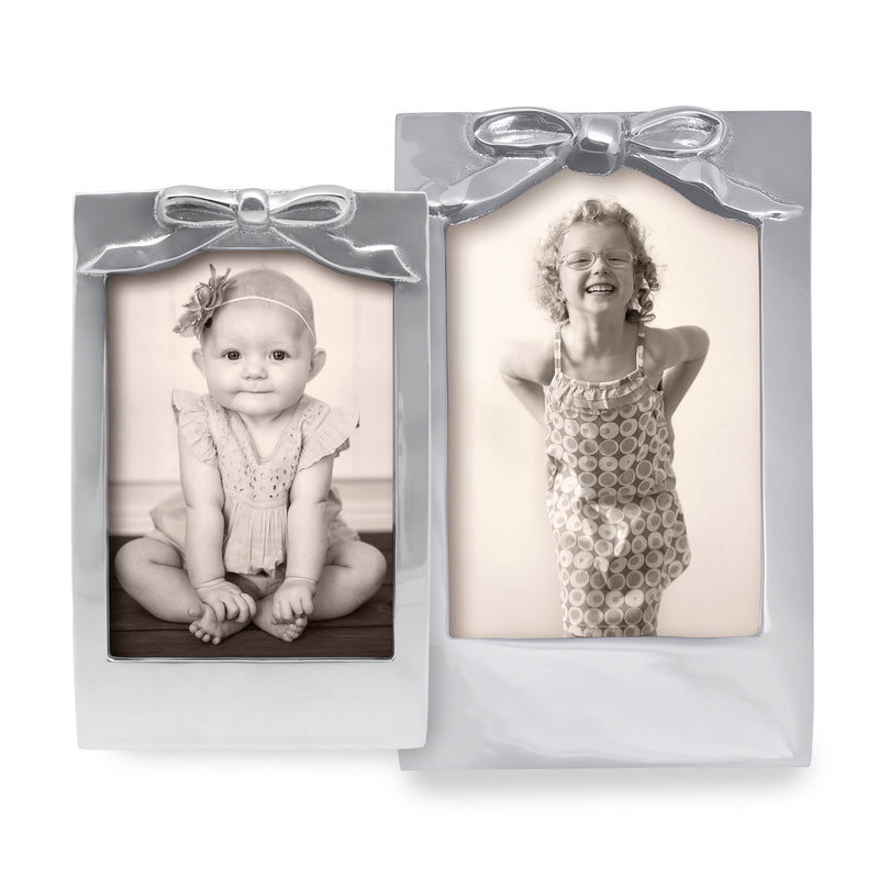Bow picture frame set with glossy silver frames and bow accents, holds 2 photos
