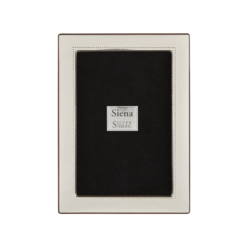 Sterling silver picture frame with wide flat border and beaded inner edge