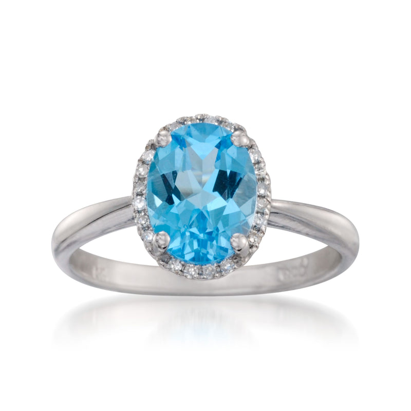 Oval Swiss blue topaz ring with diamond halo and 14kt white gold band
