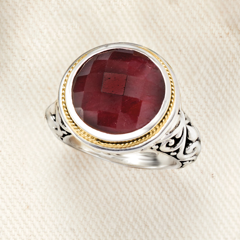 Oval ruby ring in sterling silver with gold rope bezel and swirling Bali-style shoulders