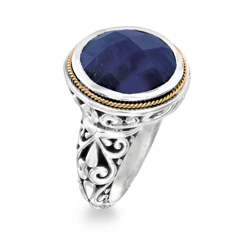 Bali-style sapphire ring with oval dark blue stone, gold rope edge on ornate silver band