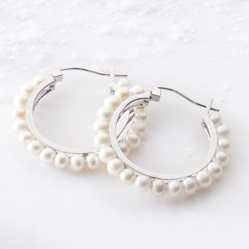Sterling silver hoop earrings with cultured 3–3.5mm pearls around the front edge