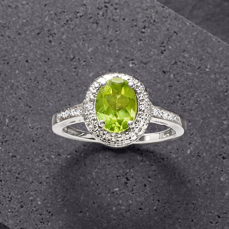Sterling silver peridot ring with round peridot center and diamond halo band