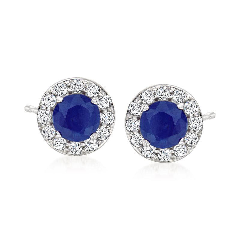 Blue sapphire stud earrings with round diamond halo, set in white gold