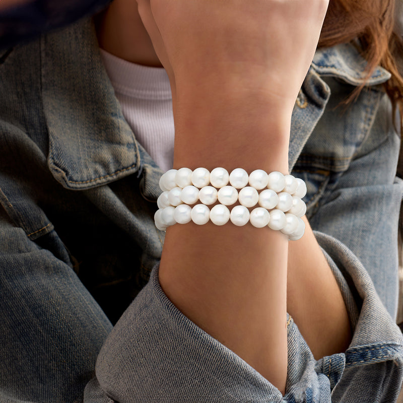 Three-strand cultured pearl stretch bracelets worn on wrist with round white beads