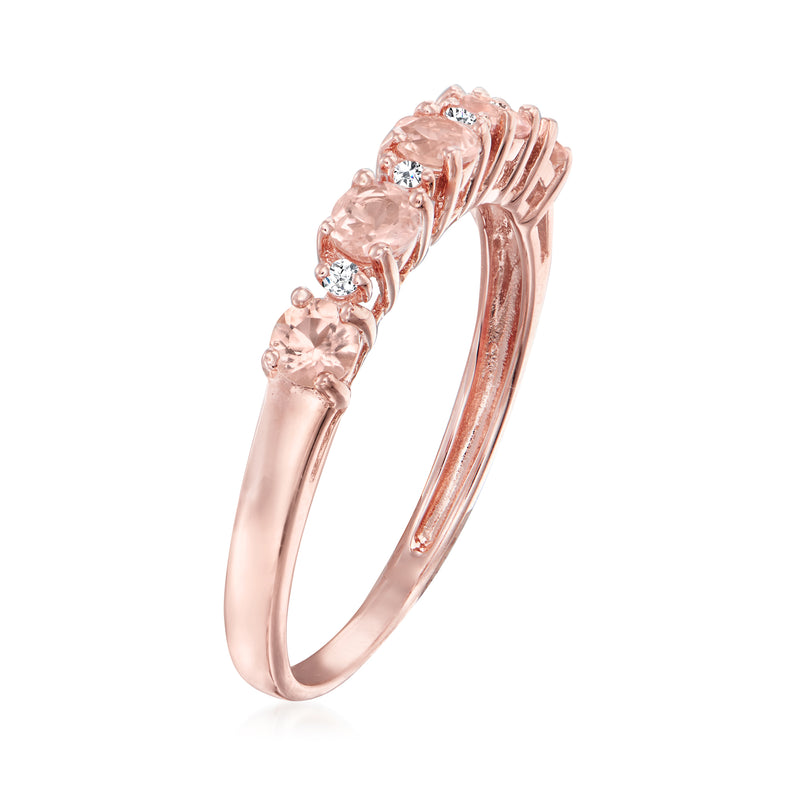 Rose gold curved band ring with pink stones and diamond details, angled view