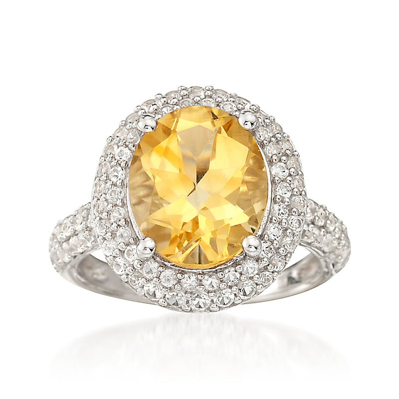Sterling silver ring with oval citrine center and halo of simulated white sapphires