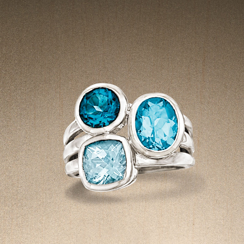 Sterling silver blue topaz three-stone ring with two dark blue and one light-blue oval gem