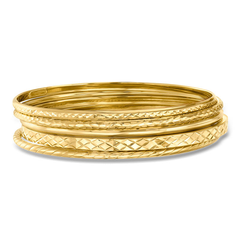 Five gold over sterling bangles with textured crisscross and polished finish