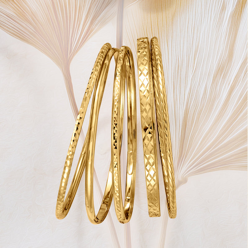 Five gold bangles shown together, diamond-pattern bands with smooth rims