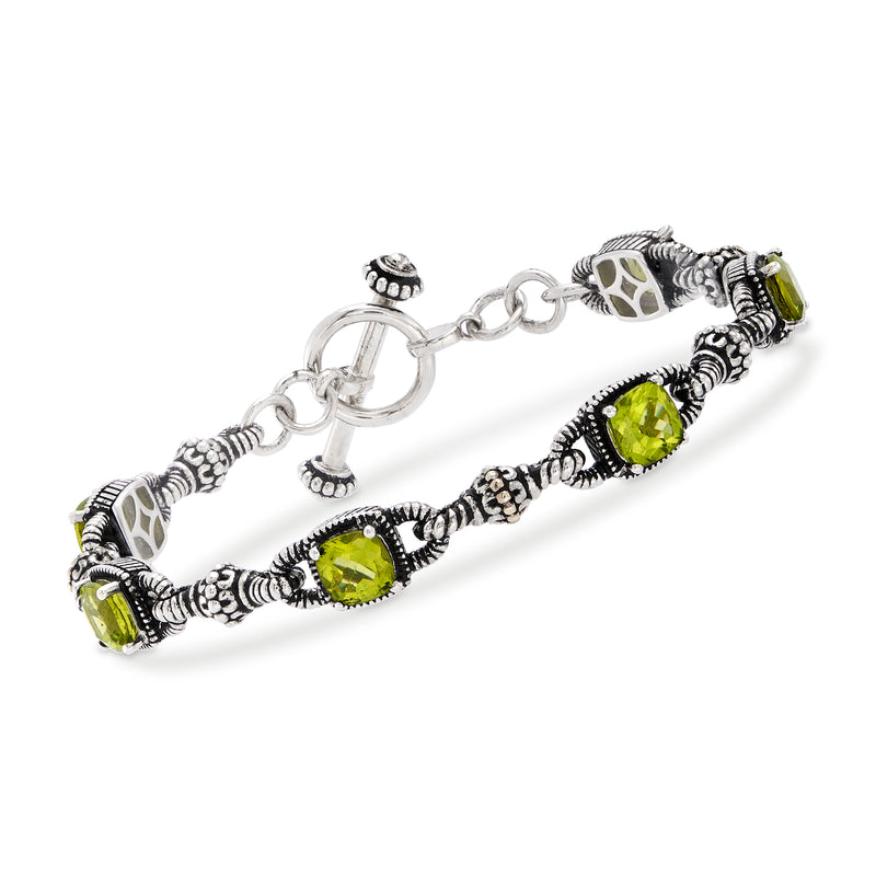 Sterling silver bracelet with oval peridot green gemstones and carved beaded accents