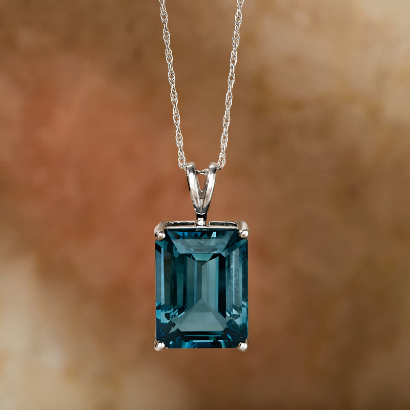 Sterling silver pendant necklace featuring a large blue emerald-cut topaz rectangle