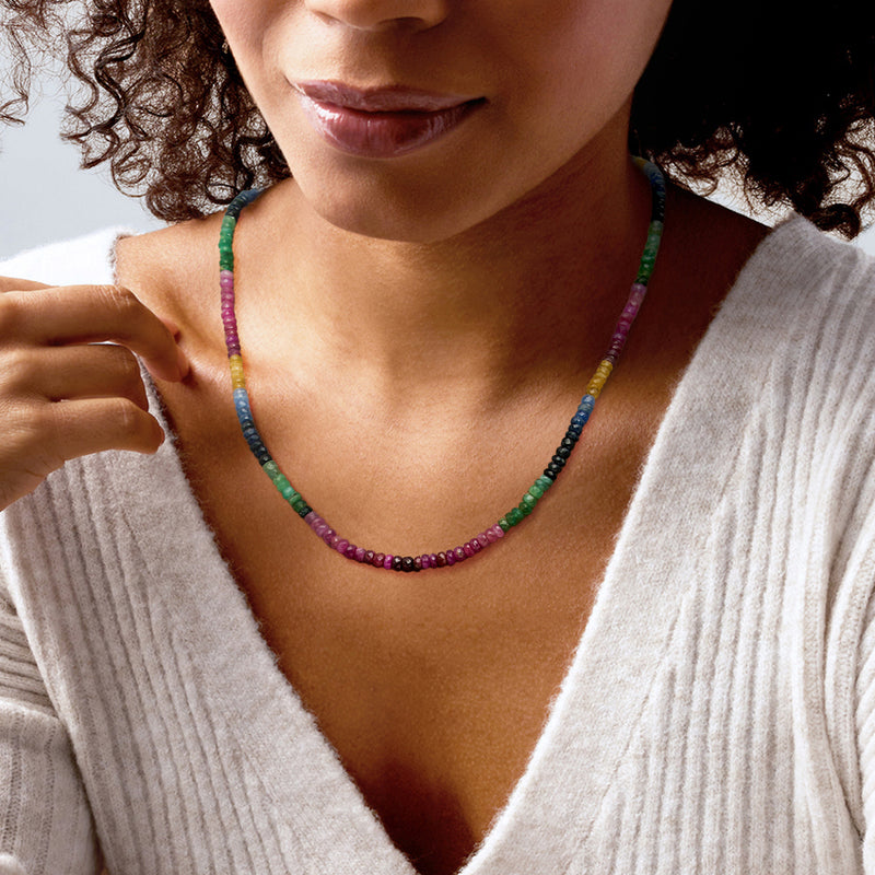 Multicolored sapphire bead necklace worn at collarbone, round beads on chain