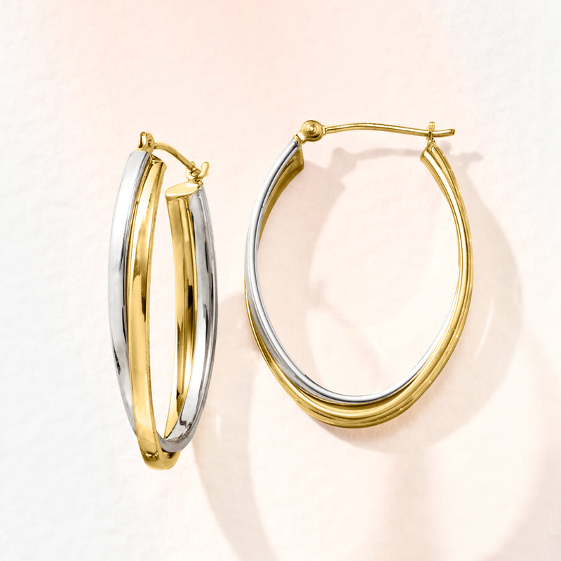 Two-tone double-oval hoop earrings, gold outer edge and silver inner oval, side view