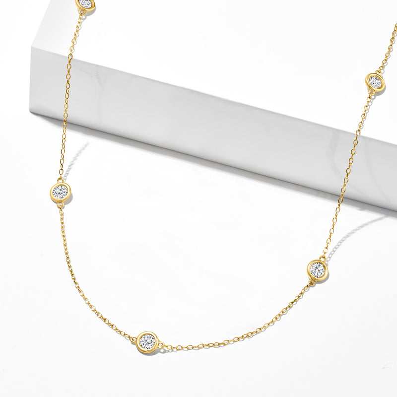 14kt yellow gold diamond station necklace on pedestal, bezel-set round diamonds